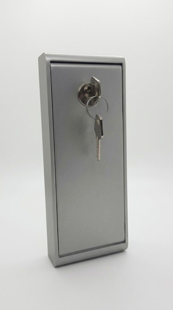 Slim, elongated aluminium external release box with the key in the lock