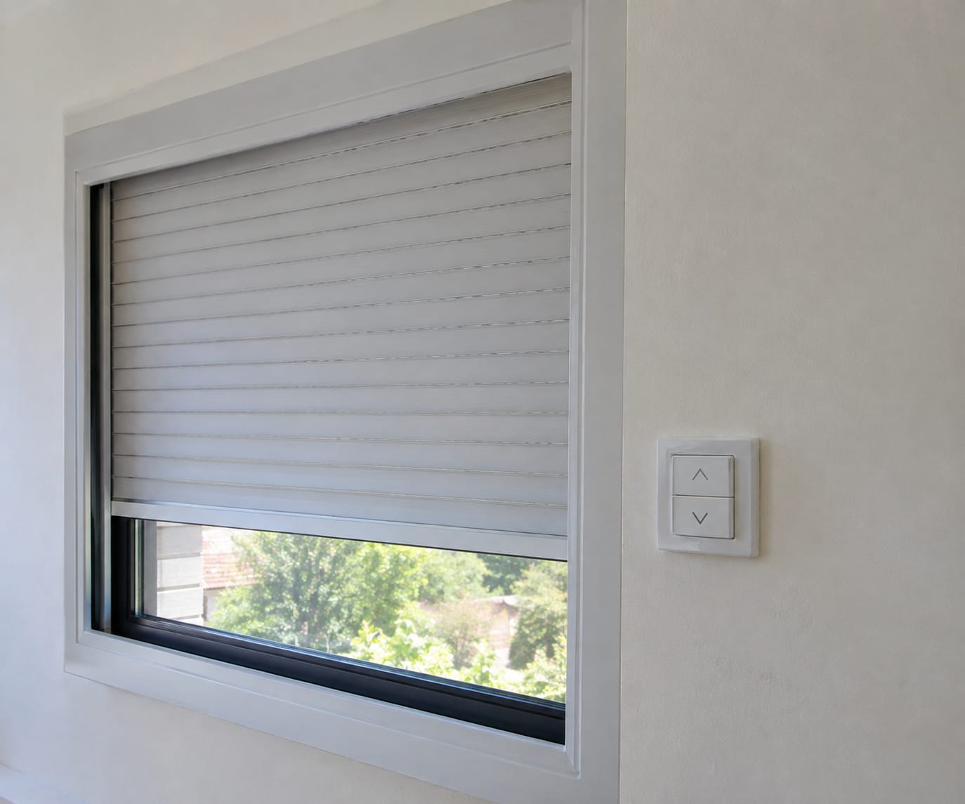 Motorised roller shutter with an up/down wall switch next to the window
